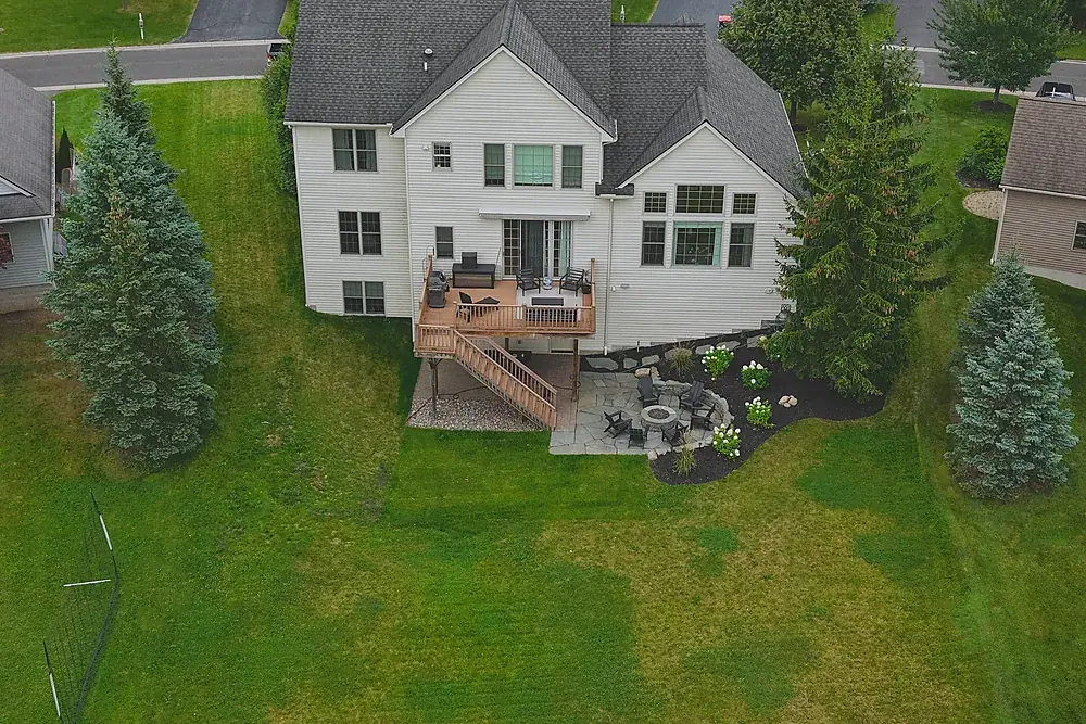 Drone photograph of the rear deck and back yard of a colonial home near Rochester, New York