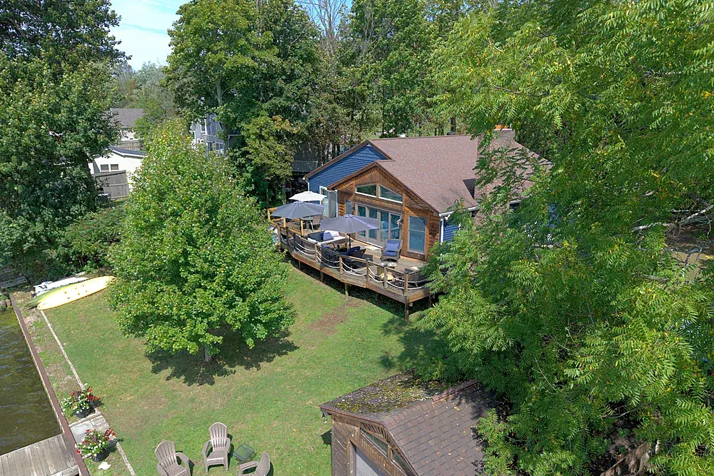 Drone photograph of a lakeside deck and shoreline at a Rochester area property